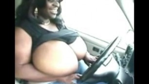 Big black tits topless in car